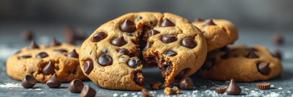 Homemade chocolate chip cookies placed on a rustic surface with scattered chocolate chips photo
