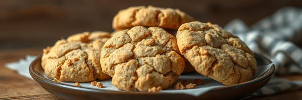 Freshly baked cookies on a wooden table with a checkered cloth in the background during afternoon light photo