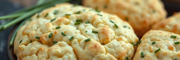 Savory herb biscuits baked to golden perfection with fresh chives and a soft, fluffy texture on display photo