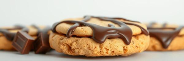 Chocolate drizzled cookies resting on a light surface during a cozy baking session at home photo