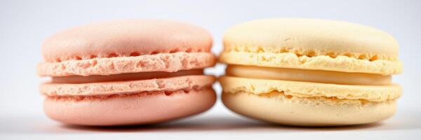 Colorful macarons in pink and yellow displayed together on a plain background highlighting their delicate texture and unique shapes photo