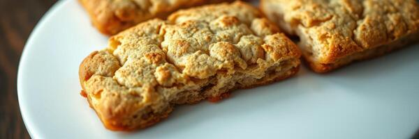 Soft baked treats on a white plate with a rustic wooden background and warm lighting photo