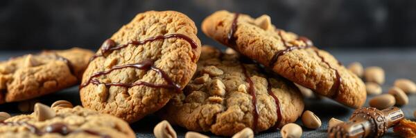 Delicious homemade peanut butter cookies with chocolate drizzle on a dark background photo