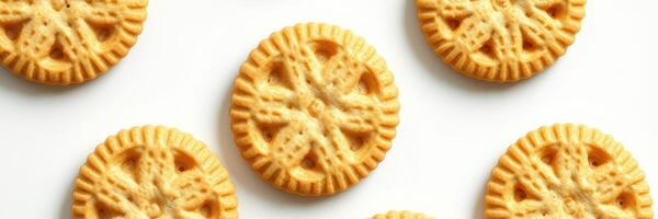 Delicious round biscuits with intricate patterns arranged on a white surface photo