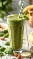 Refreshing green smoothie with spinach and banana served in a tall glass on a wooden table photo