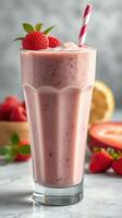 Refreshing strawberry raspberry smoothie on a marble countertop with fresh berries and waffle cones in the background photo
