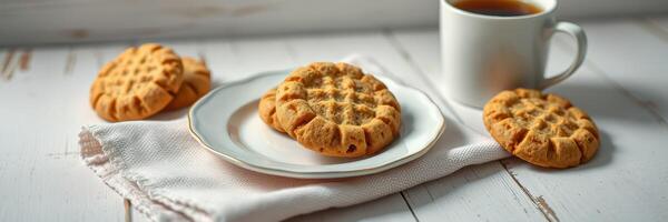 Warm cookies on a plate with a cup of coffee and a cozy setting during morning hours photo