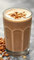 Delightful nutty drink topped with toasted seeds served in a glass on a stone surface photo