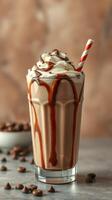 Delicious chocolate milkshake topped with whipped cream and chocolate drizzle in a glass photo