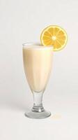 Refreshing lemon smoothie served in a tall glass with a lemon slice for garnish on a plain background photo