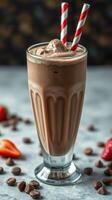 Delicious chocolate milkshake with whipped cream and strawberries on a marble tabletop photo