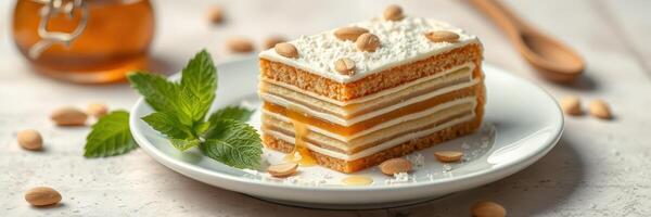 Delicious dessert slice with nuts and honey served on a plate with fresh mint photo