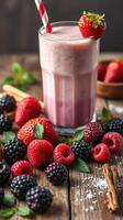 Fresh berry smoothie with strawberries, raspberries, blackberries, and blueberries on wooden table photo