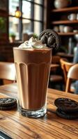 Creamy chocolate drink topped with whipped cream and cookies in a cozy cafe setting photo