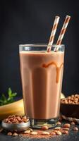 Chocolate banana smoothie with decorative straws and cocoa nibs displayed on a dark background photo