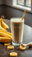 Creamy banana smoothie served in a tall glass with fresh bananas on a wooden table in a cozy setting photo