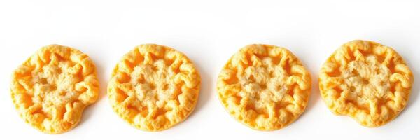 Crunchy golden cookies arranged in a row on a plain white background photo