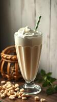 Delicious creamy milkshake topped with whipped cream and a green straw on a rustic wooden table photo