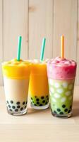 Colorful bubble tea drinks served in tall glasses with vibrant toppings and straws at a dessert cafe photo