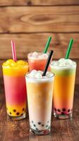 Colorful bubble tea drinks arranged on wooden table in a cozy setting during an afternoon gathering photo