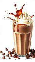 Delicious chocolate drink with cream and caramel topping served in a tall glass amidst chocolate pieces photo