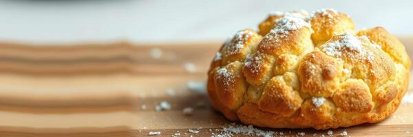 Freshly baked pastry garnished with powdered sugar on a wooden surface photo