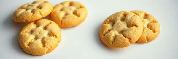 Freshly baked cookies arranged on a white surface showcasing golden color and unique designs photo
