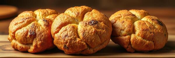 Freshly baked bread rolls arranged neatly on a wooden platter in a cozy kitchen setting photo