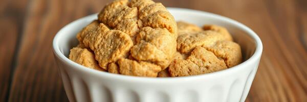 Delicious homemade cookies in a white bowl on a wooden surface photo