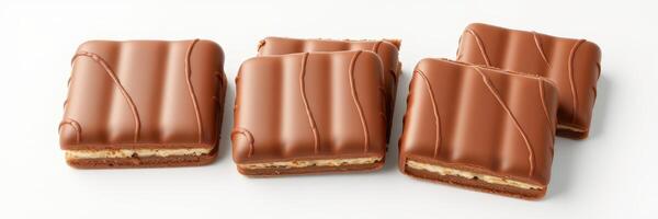 Delicious chocolate-covered snack squares arranged on a clean surface for a tempting dessert experience photo