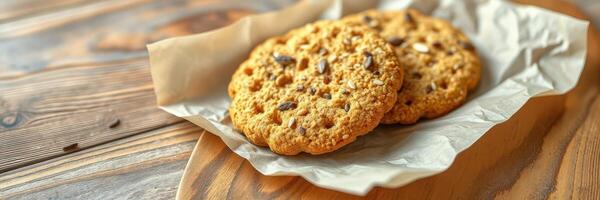 Freshly baked cookies served on parchment paper with a rustic wooden background during a cozy afternoon photo