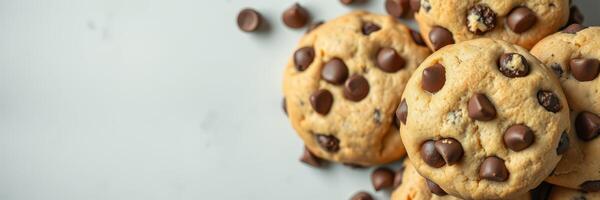 Freshly baked chocolate chip cookies on a light surface, perfect for sharing and enjoying at any time of day photo