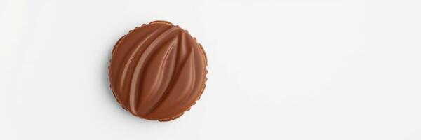 Chocolate treat sits on a clean surface, showcasing its smooth, glossy texture and unique shape photo
