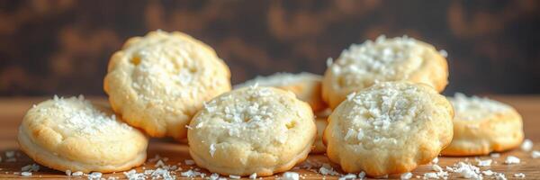 Deliciously baked coconut cookies arranged on a wooden surface with a textured background photo