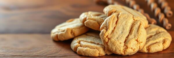 Delicious homemade cookies arranged on a wooden table with rustic kitchen utensils in the background photo