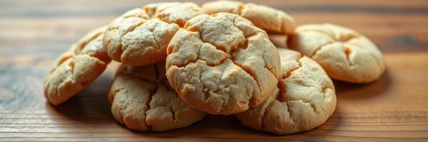 Delicious homemade cookies stacked on a wooden table ready for enjoying with friends or family during a cozy gathering photo