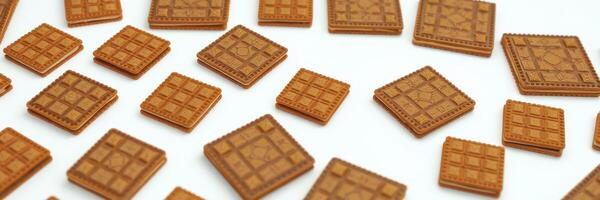 Unique collection of brown square decorative tiles arranged on a white surface for crafting or design projects photo