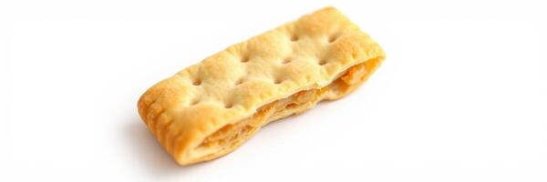 Crunchy snack cracker rests on a white surface showcasing its texture and shape in natural light photo