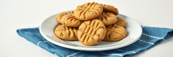 Freshly baked peanut butter cookies on a blue towel ready for serving photo