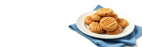Freshly baked peanut butter cookies on a white plate with a blue napkin photo