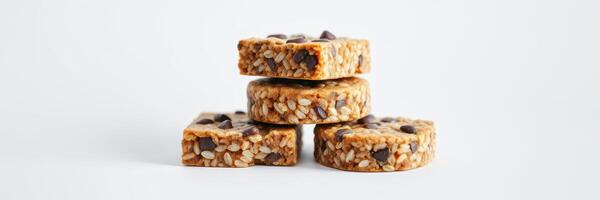 Healthy snack bars stacked on each other with chocolate chips and a simple background photo