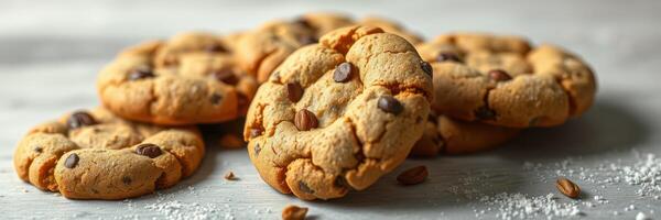 Freshly baked chocolate chip cookies on a gray surface, perfect for a sweet treat at any time of day photo