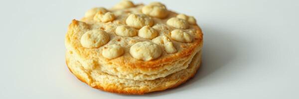 Soft biscuit with a golden crust and dotted top on a plain background revealing its fluffy texture and inviting appearance photo