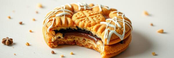 Cookie with chocolate and caramel filling, decorated with icing on a clean surface photo