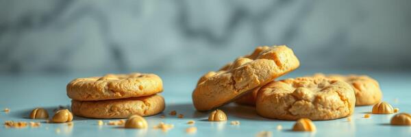 Freshly baked cookies with a golden color arranged on a light blue surface with scattered crumbs photo