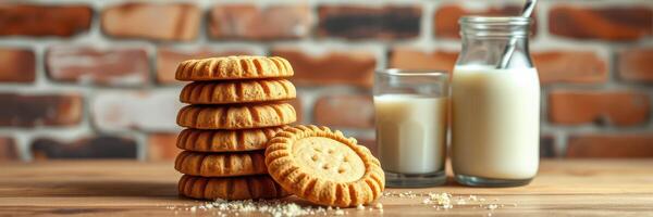 Delicious cookies paired with a glass of milk on a wooden table against a brick wall photo