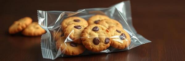 Freshly baked chocolate chip cookies in a clear plastic bag on a wooden table photo