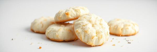 Coconut macaroons arranged on a plain surface ready for a dessert feast at a sunny kitchen photo