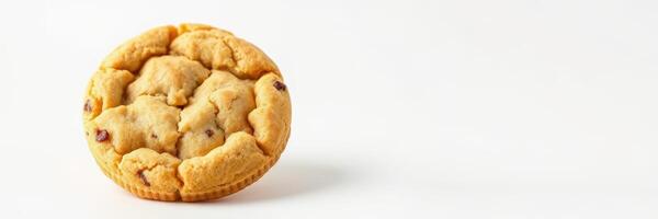 Freshly baked chocolate chip cookie resting on a plain surface, inviting and warm for a delightful treat photo