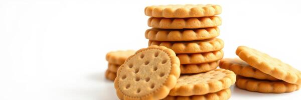 Stacked golden biscuits arranged in a neat pile on a plain white background perfect for snack time photo